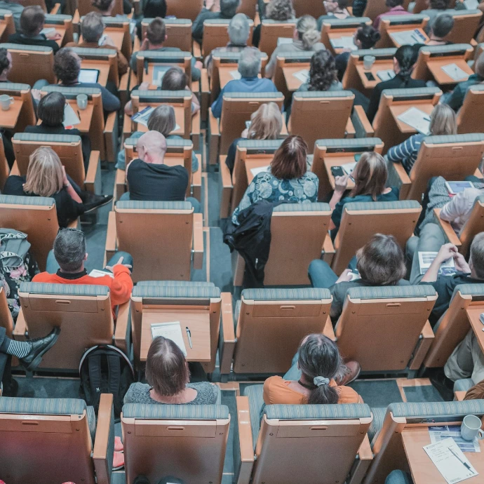 high-angle photography of group of people sitting at chairs