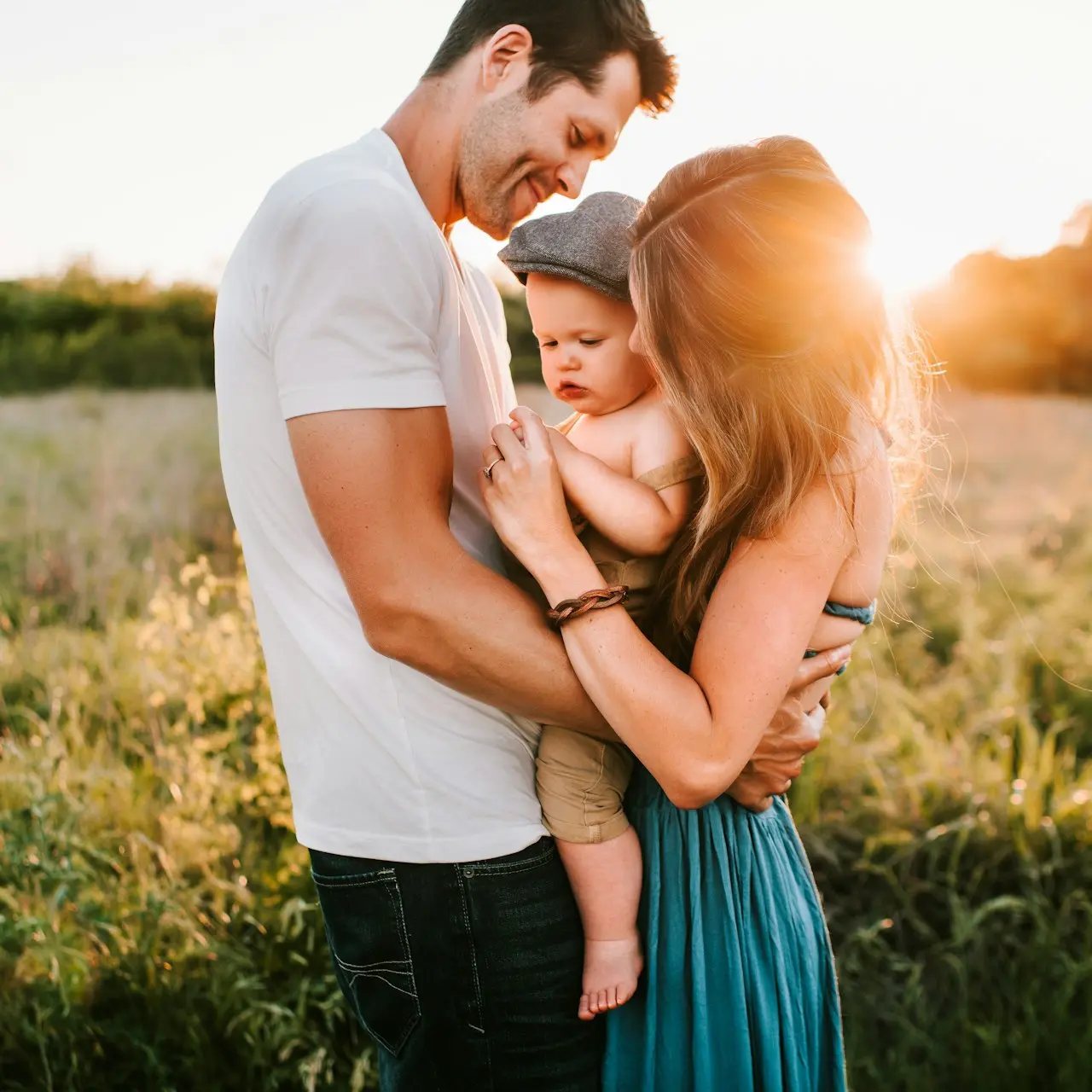 family photo on green grass during golden hour